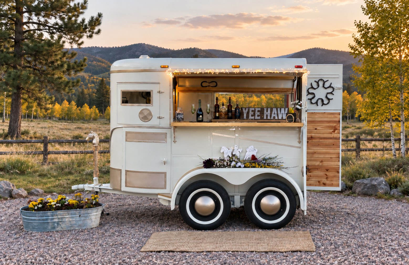 Pony Pub’s restored white horse trailer bar in a Colorado autumn landscape.